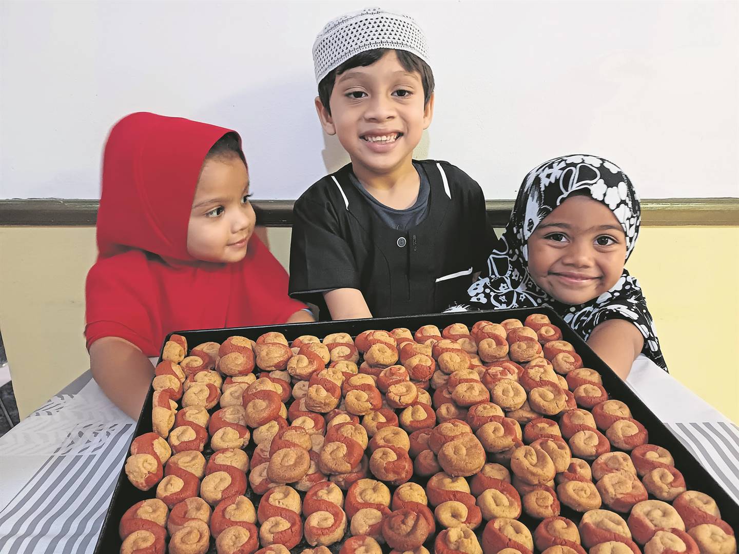 Essies are synonymous with Eid in Gqeberha. Freshly baked and ready for Eid, from left, Yusra Dowers (3) Ammaar Shaikh (6) and Haadiya Cupp (3) are waiting to enjoy their share.