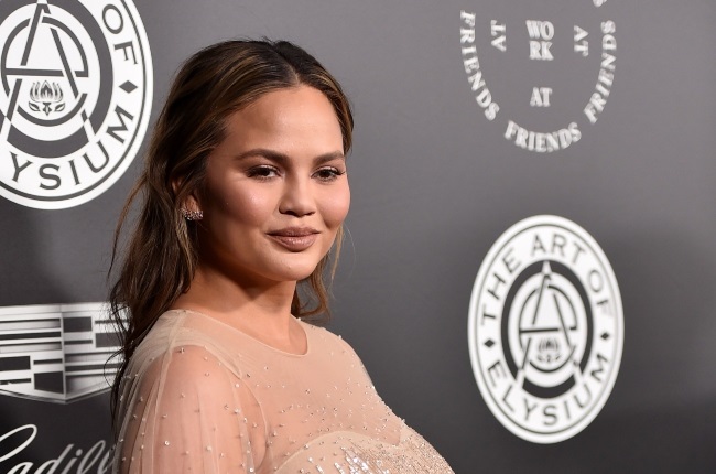 Chrissy Teigen has revealed she takes the ashes of her late son Jack with her on family trips at the insistence of her two children. (PHOTO: Gallo Images / Getty Images)