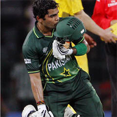 Umar Akmal kisses his helmet after Pakistan's win against Australia. (AFP)