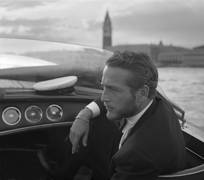 American actor Paul Newman, wearing a tuxedo and a bow tie, portrayed during a trip on a water taxi, a sailor cap on the dashboard, St. Mark Square in the background, Venice 1963. (Photo by Archivio Cameraphoto Epoche/Getty Images)