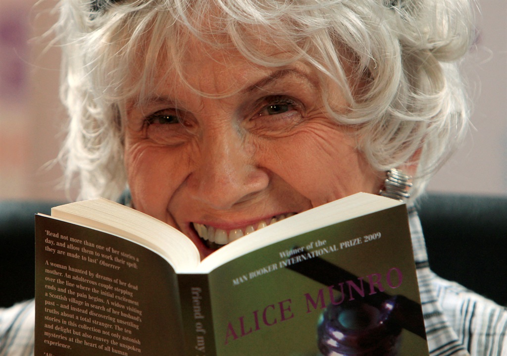 Canadian author Alice Munro holds one of her books
