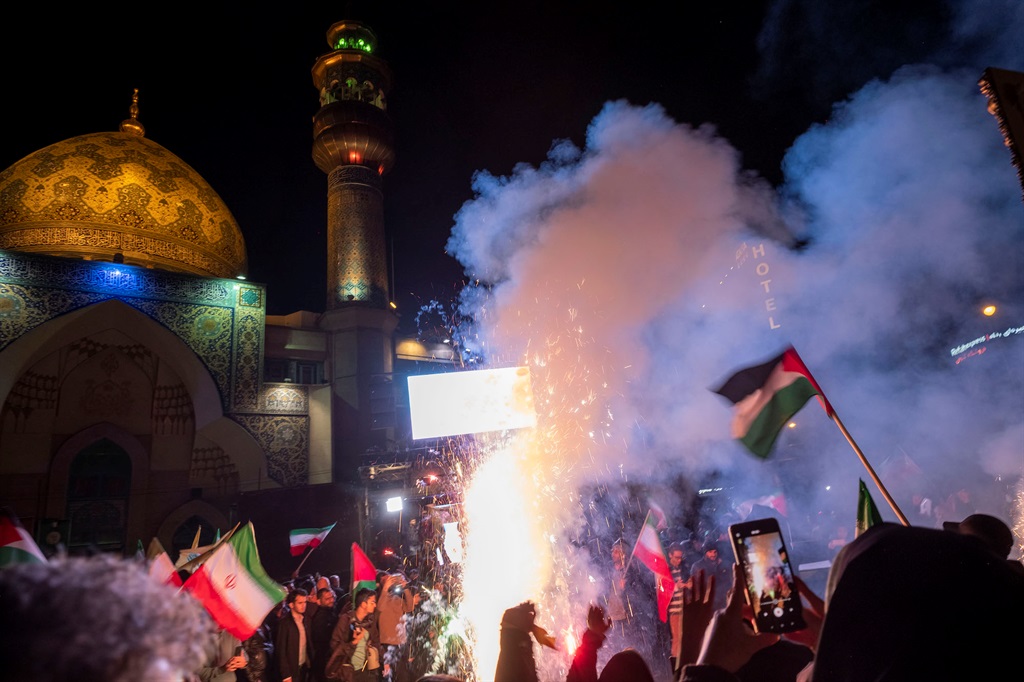Iranians celebrate the attack against Israel in downtown Tehran on 14 April 2024. (Morteza Nikoubazl/NurPhoto via Getty Images)