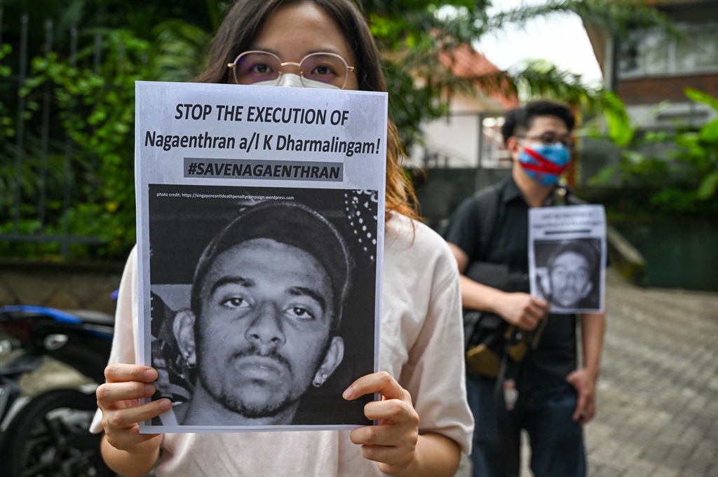 Activists hold placards before submitting a memorandum to parliament in protest at the impending execution of Nagaenthran K. Dharmalingam, sentenced to death for trafficking heroin into Singapore, in Kuala Lumpur on November 3, 2021.
(Photo: Mohd RASFAN / AFPP