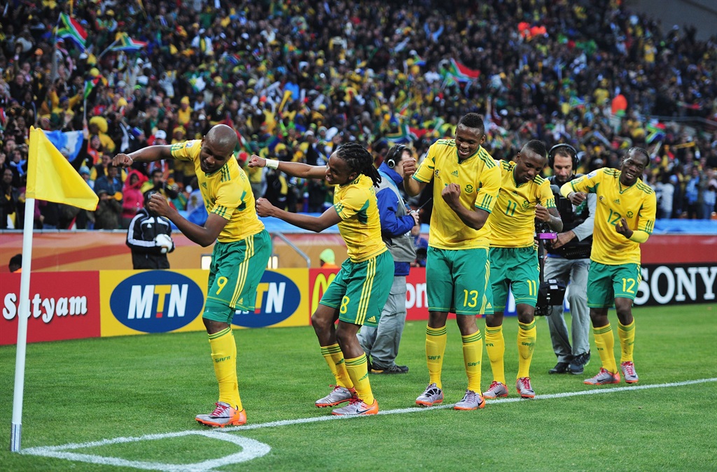 Siphiwe Tshabalala of South Africa celebrates scoring the first goal with team mates during the 2010 FIFA World Cup Group A match between Bafana Bafana and Mexico at the FNB Stadium on 11 June 2010 in Johannesburg, South Africa.  
