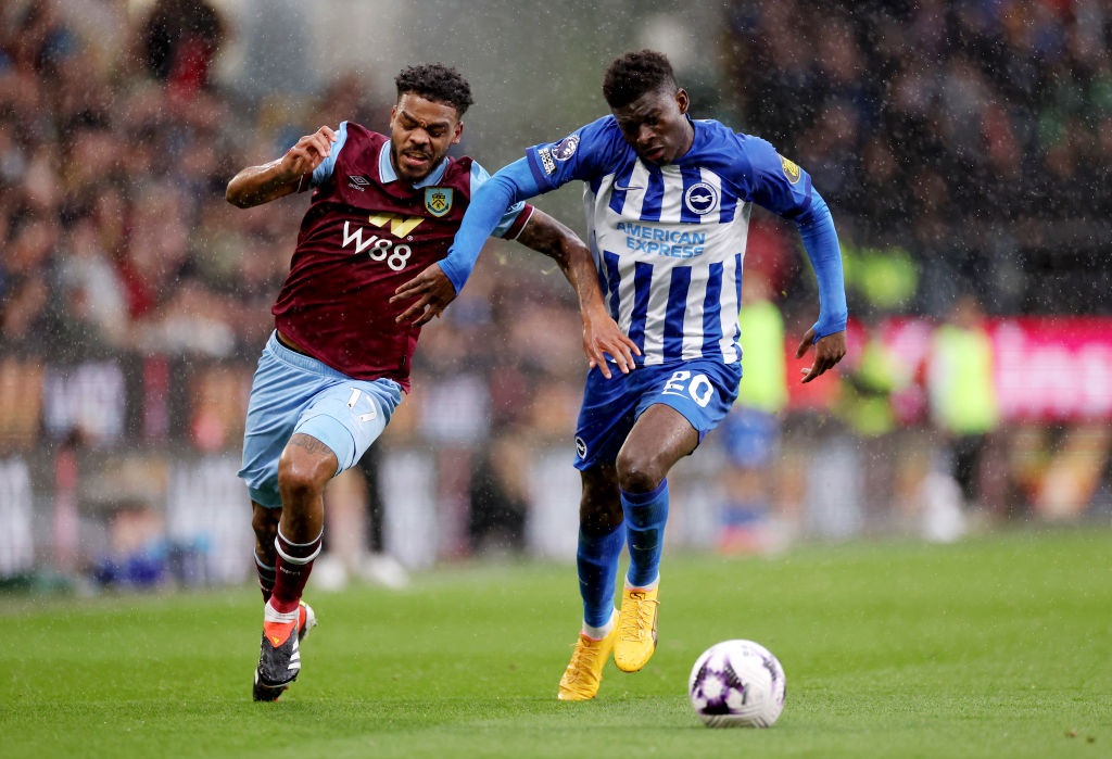 BURNLEY, ENGLAND - APRIL 13: Lyle Foster of Burnley battles for possession with Carlos Baleba of Brighton & Hove Albion during the Premier League match between Burnley FC and Brighton & Hove Albion at Turf Moor on April 13, 2024 in Burnley, England. (Photo by Lewis Storey/Getty Images)