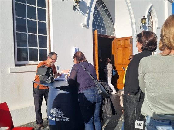 Zapiro is putting his pen to work outside the NG Church, signing copies of his new collection. <em>(Leandra Engelbrecht/News24)</em>