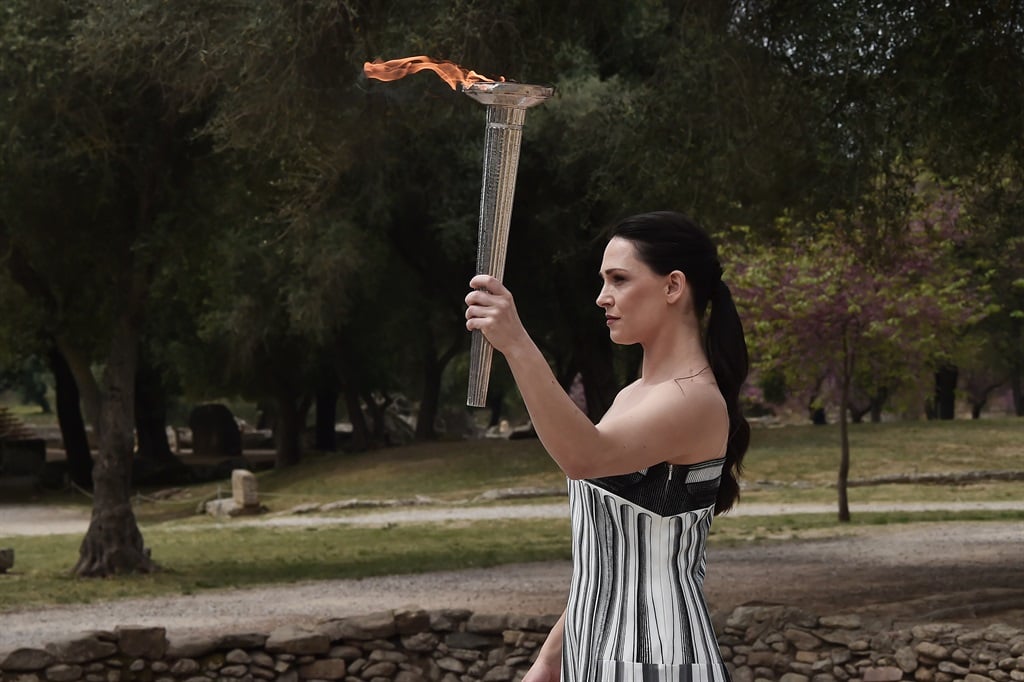 ATHENS, GREECE - APRIL 16: Greek actress Mary Mina, playing the role of the High Priestess, carries the torch during the flame lighting ceremony for the Paris 2024 Summer Olympics at the Ancient Olympia archeological site, birthplace of the ancient Olympics in southern Greece on April 16, 2024 in Olympia, Greece. )
