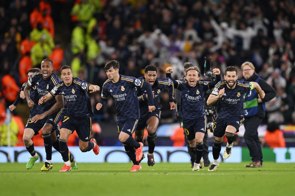 MANCHESTER, ENGLAND - APRIL 17: Real Madrid players celebrate after Antonio Ruediger of Real Madrid (not pictured) scored the sides winning penalty in the penalty shoot out during the UEFA Champions League quarter-final second leg match between Manchester City and Real Madrid CF at Etihad Stadium on April 17, 2024 in Manchester, England. (Photo by Stu Forster/Getty Images)