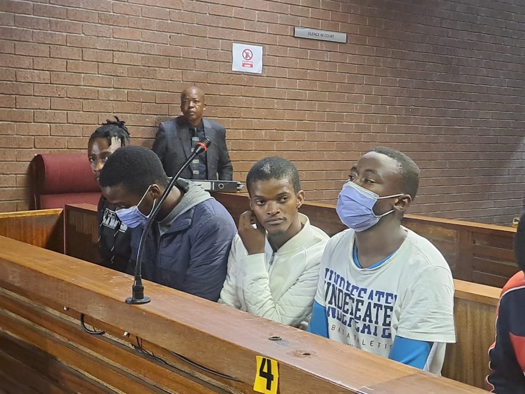 Accused number one to four (from left to right) sit in the dock for their second appearance at the Roodepoort Magistrates' Court on 19 April 2024. Six men are in custody facing five charges, including the murder of Kaizer Chiefs player Luke Fleurs