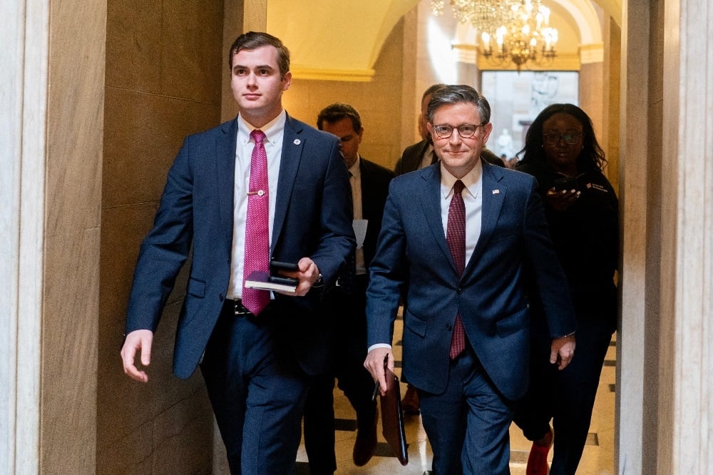 Speaker of the House Mike Johnson (right) walks toward the House Chamber at the US Capitol on 20 April 2024 in Washington, DC. (Nathan Howard/Getty Images North America/Getty Images via AFP)
