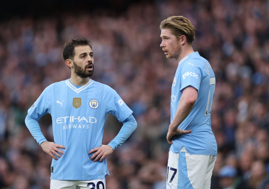 MANCHESTER, ENGLAND - MARCH 03: Bernardo Silva of Manchester City talks to Kevin De Bruyne during the Premier League match between Manchester City and Manchester United at Etihad Stadium on March 03, 2024 in Manchester, England. (Photo by Catherine Ivill/Getty Images)