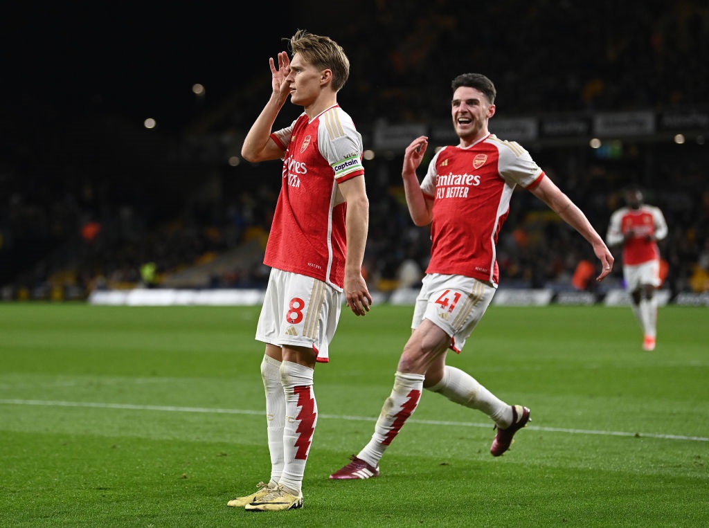 WOLVERHAMPTON, ENGLAND - APRIL 20: Martin Odegaard of Arsenal celebrates scoring his teams second goal with teammate Declan Rice during the Premier League match between Wolverhampton Wanderers and Arsenal FC at Molineux on April 20, 2024 in Wolverhampton, England. (Photo by Gareth Copley/Getty Images)