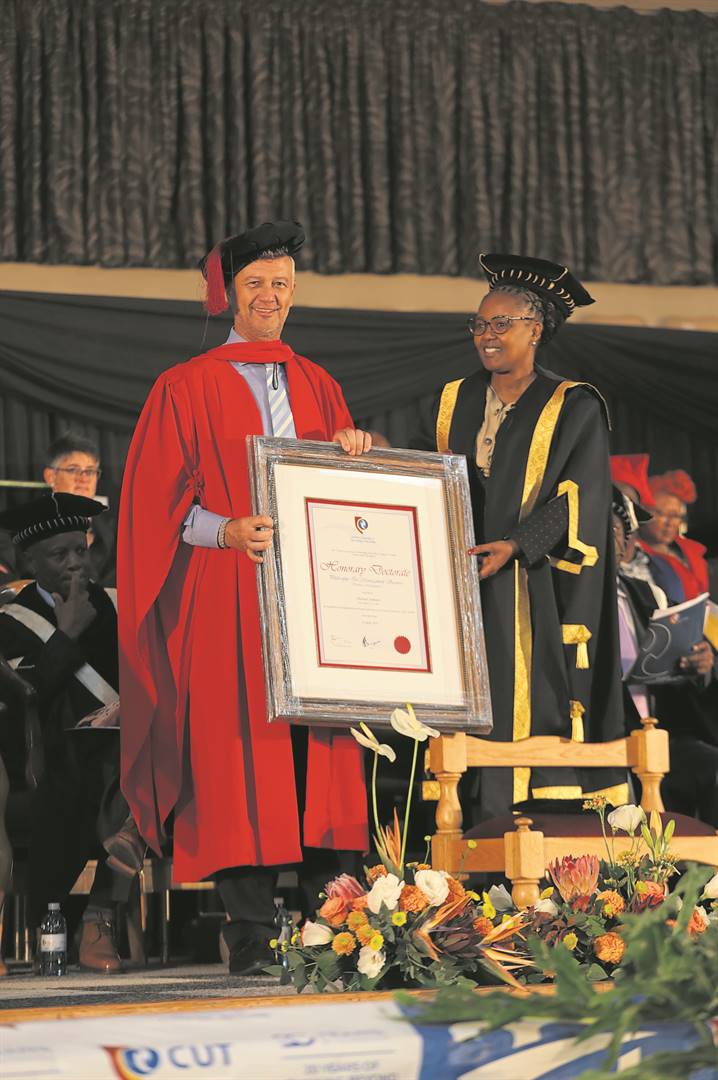 Dr Michael Jordaan receiving his Honorary Doctor of Philosophy in Management degree at the CUT’s autumn graduation ceremony, with Prof Pamela Dube, vice-chancellor for the CUT.Photo: Supplied