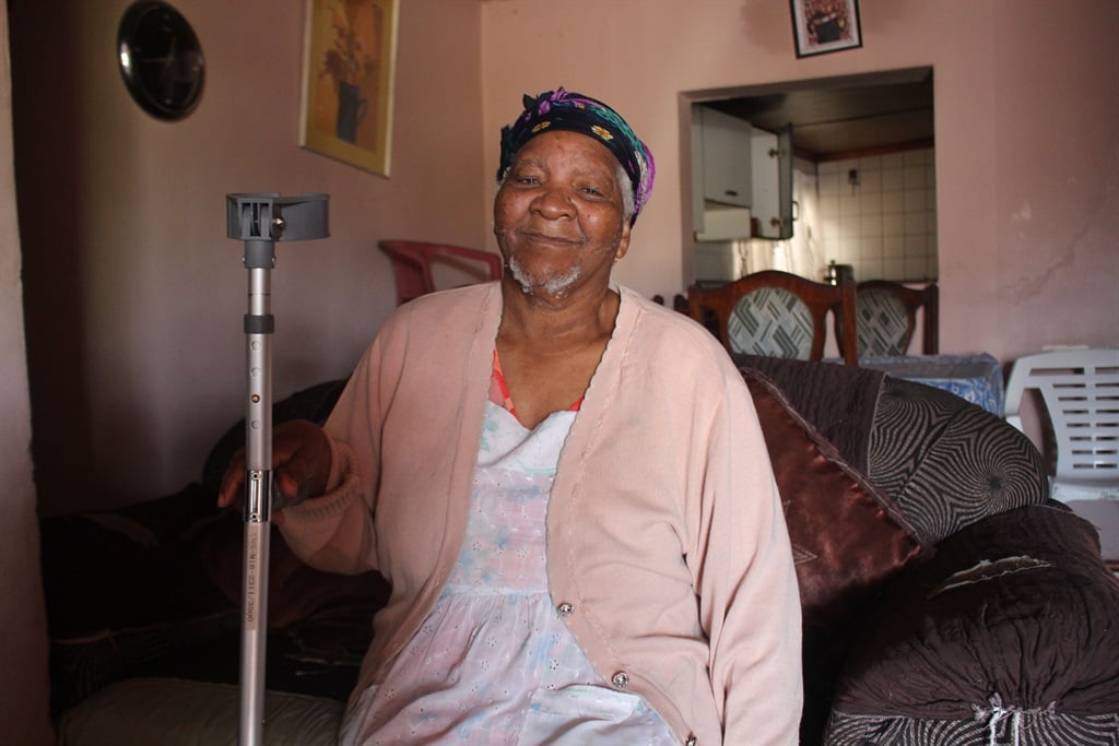 Gogo Nkala relies on her walking stick to get her 