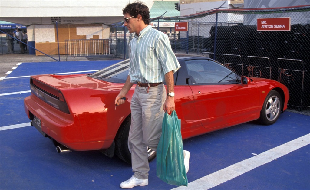 Ayrton Senna walking away from his Honda NSX. [Ima