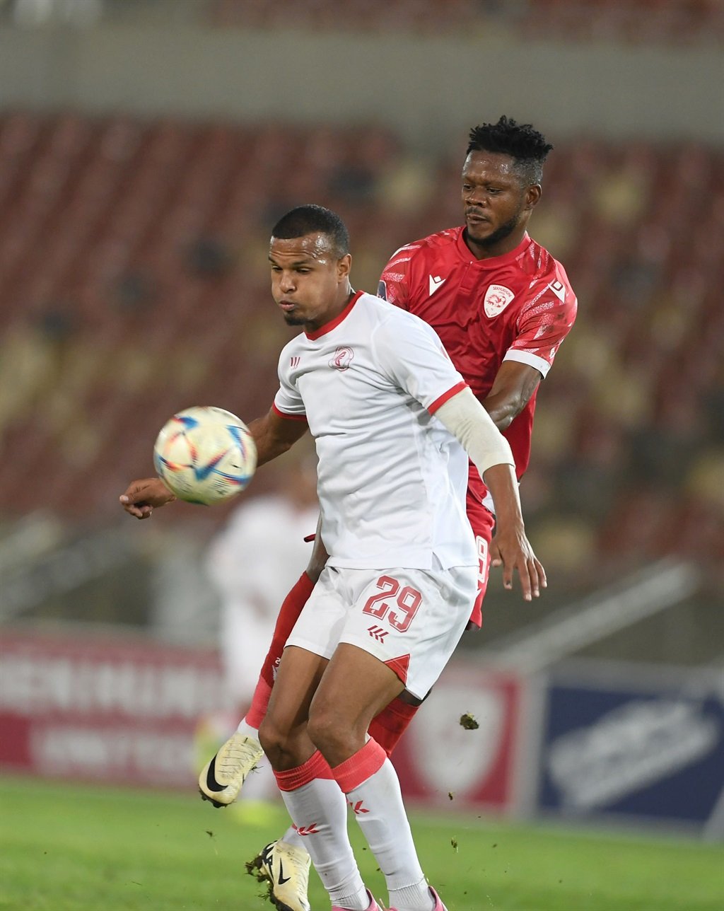 POLOKWANE, SOUTH AFRICA - APRIL 20: Ashley Cupido of Cape Town Spurs and Tresor Tshibwabwa of Sekhukhune United during the DStv Premiership match between Sekhukhune United and Cape Town Spurs at Peter Mokaba Stadium on April 20, 2024 in Polokwane, South Africa. (Photo by Philip Maeta/Gallo Images)