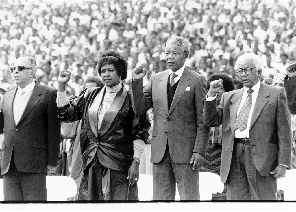 An ANC rally, after Nelson Mandelas release from prison in 1990 at Soweto Soccer Stadium, Johannesburg. From left to right: Ahmed Kathrada, Winnie Madikizela-Mandela, Nelson Mandela and Walter Sisulu. (Die Burger)