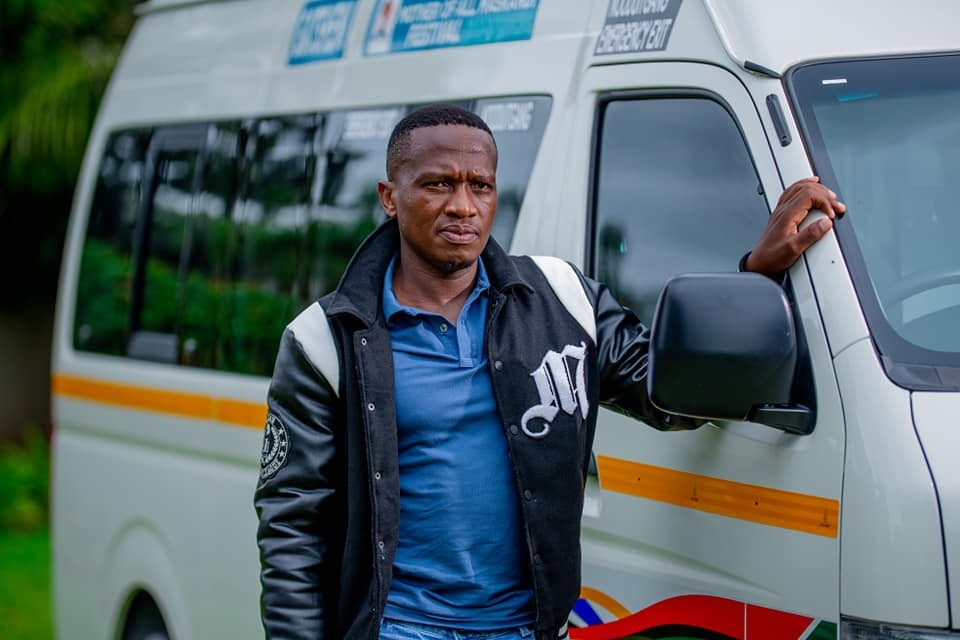  Khuzani "Gatsheni" Ndlovu standing next to the taxi he won.