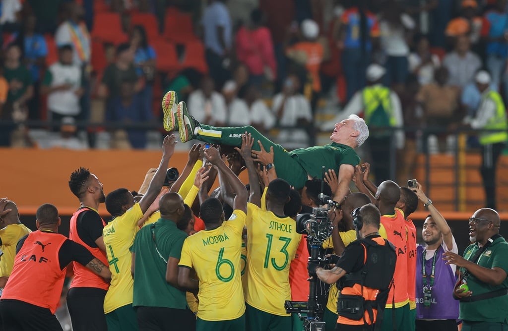 ABIDJAN, IVORY COAST - FEBRUARY 10: South African players celebrates with Hugo Henri Broos (Head Coach) of South Africa after winning the penalty shoot out of the TotalEnergies CAF Africa Cup of Nations, 3rd Place Playoff match between South Africa and Democratic Republic Of Congo at Stade Felix Houphouet Boigny on February 10, 2024 in Abidjan, Ivory Coast. (Photo by Didier Lefa/Gallo Images)