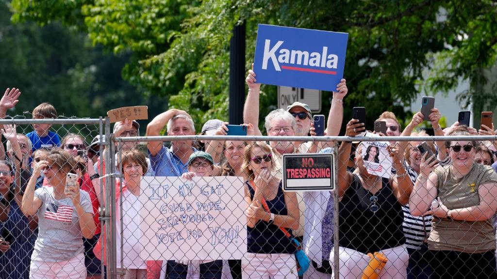 Supporters wave and holds signs as US Vice Preside