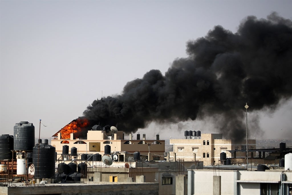 Thick, black smoke rises from a building in Rafah on 10 May 2024. (AFP)
