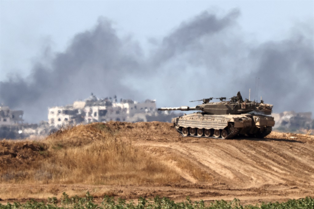 An Israeli army battle tank takes a position in southern Israel near the border with the Gaza Strip on 13 May 2024, amid the ongoing conflict in the Palestinian territory between Israel and Hamas. (Jack Guez/ AFP)