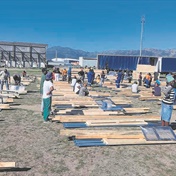 Shack dwellers receive new building material for damaged homes