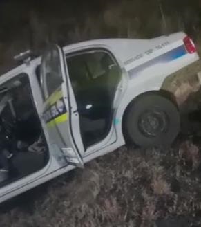 A screenshot of a video in which a seemingly intoxicated cop struggled to get out of the car. 