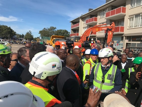 <p>President Ramaphosa arrives at collapsed George building
site

President Cyril Ramaphosa is at the scene of a collapsed
construction site in George. </p><p>The president is expected to meet with the
families of those who were trapped when the building collapsed.
</p><p>Colin Deiner, Head of Disaster Management in the Western
Cape is briefing the president on the rescue efforts, including the successful
recovery of more than 20 survivors from the rubble. </p><p><em>- Nicole McCain</em></p><p><em>(Photo
by Alfonso Nqunjana/News24)</em><em></em></p>