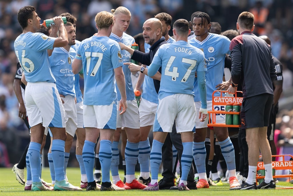 Manchester City coach Pep Guardiola gives instructions to his players in one of the team's Premier League matches