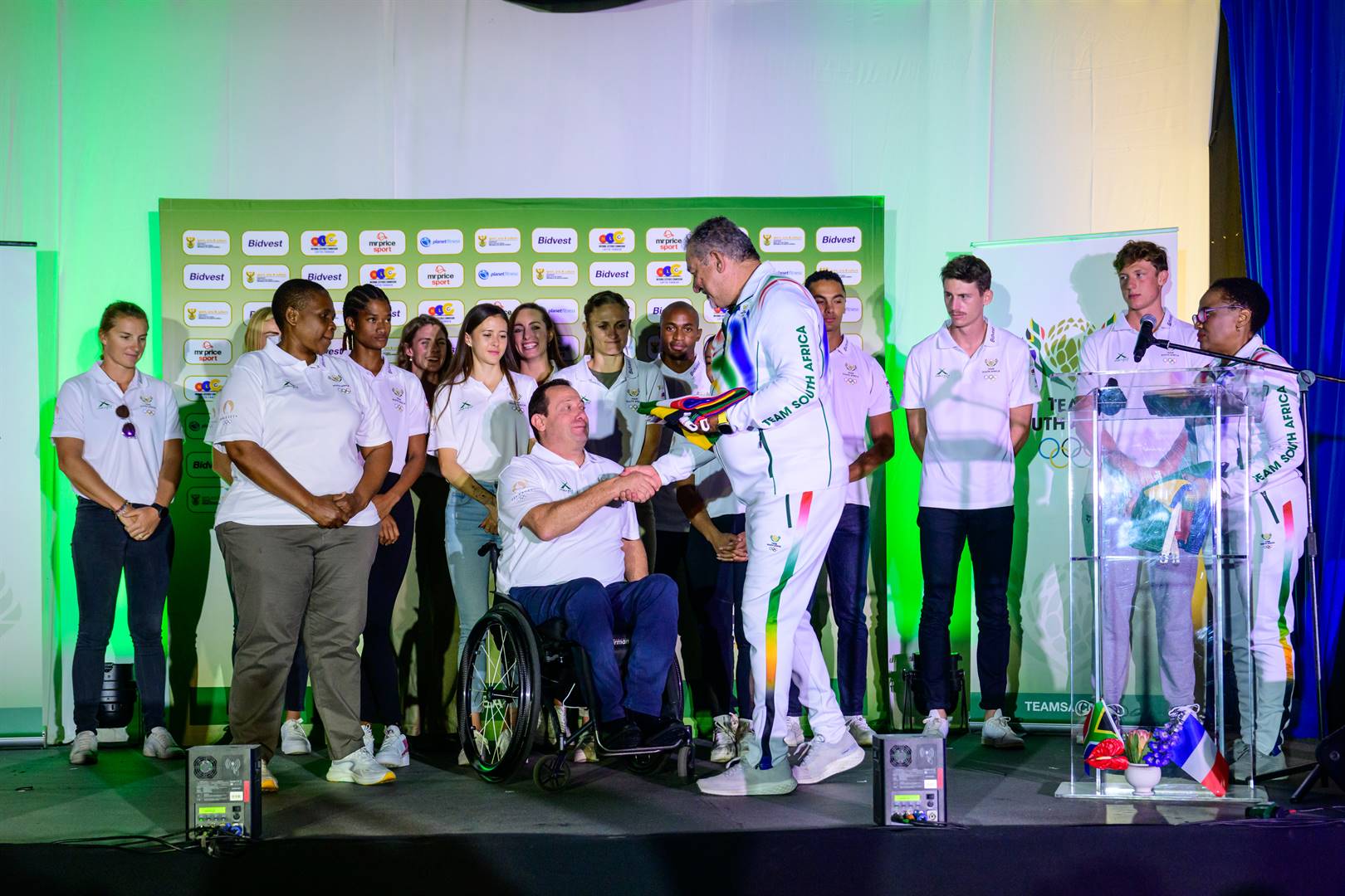Sascoc president Barry Hendricks hands over the national flag to Team SA chef de mission Leon Fleiser during the announcement of the first batch of Paris-bound athletes at Olympic House in Johannesburg this week.