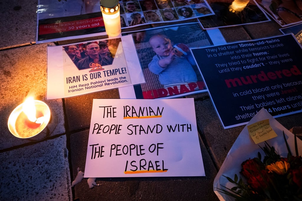 A letter of support from "the Iranian people" with images of victims of the 7 October attack in Israel, during a demonstration in support of Israel in Stockholm five days after the Hamas attack. (Jonathan NACKSTRAND / AFP)