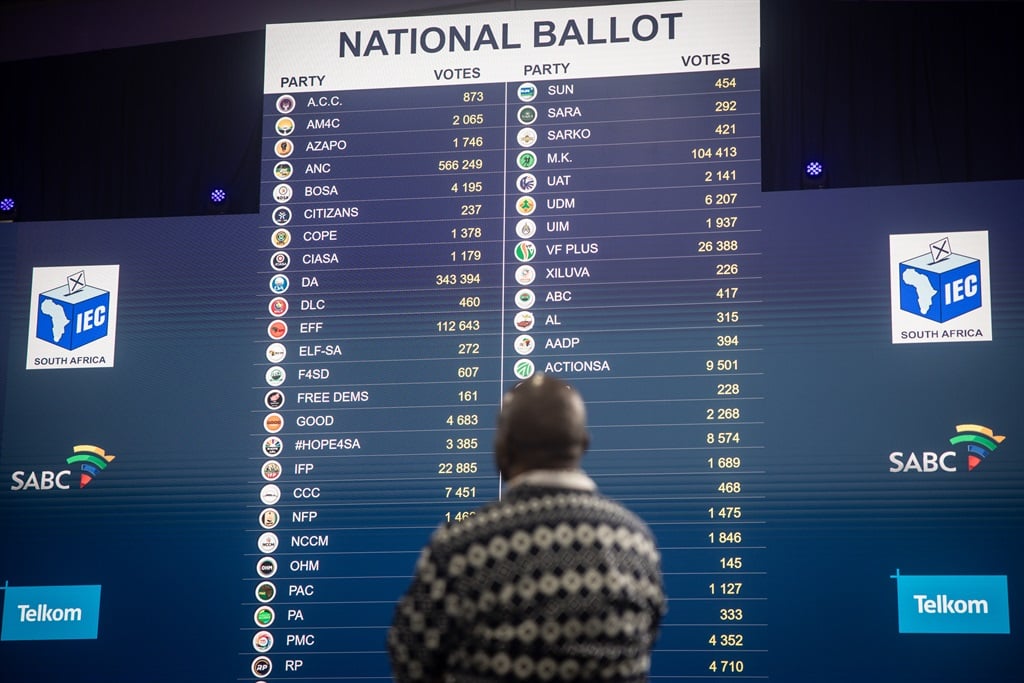 A man looks at live voting results at the IEC National Results Centre on 30 May 2024 in Johannesburg, South Africa. (Chris McGrath/Getty Images)