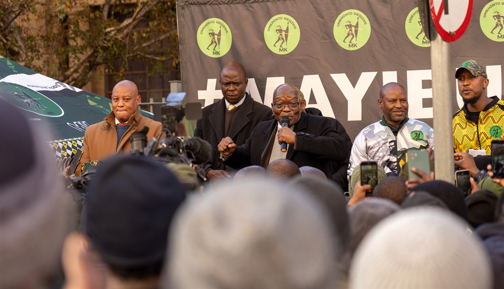 Former president Jacob Zuma singing following an u
