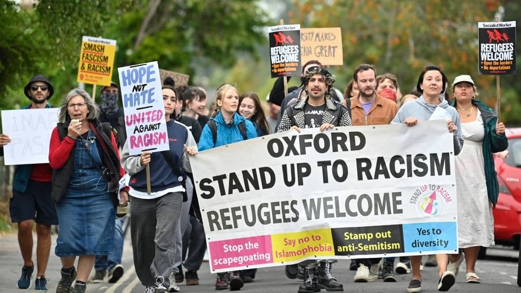 Protesters march with a banner during a counter de