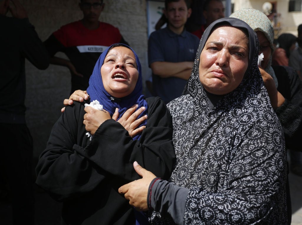 Palestinian women mourn as the bodies of the Palestinians killed in the Israeli attack are brought to the morgue of Al-Aqsa Martyrs Hospital in Deir al-Balah, Gaza on June 8, 2024.