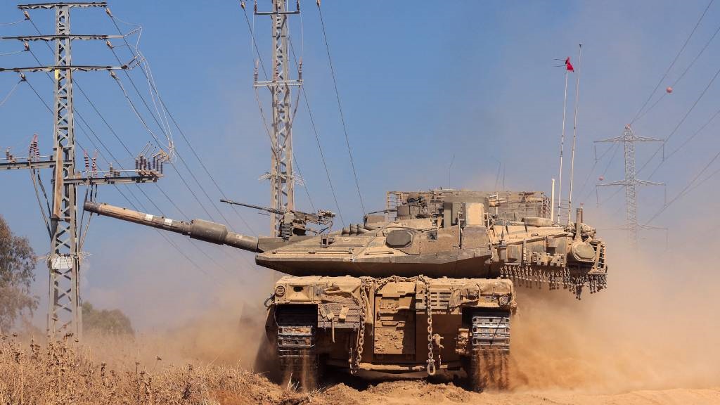 An Israeli army tank rolls in an area near Israel'