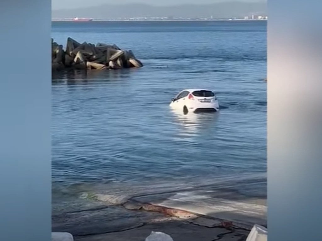 The young motorist narrowly escaped injury when his vehicle seemingly slid down the slipway and landed in the water. (YouTube screengrab)

