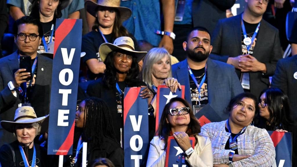 Attendees react as former US President Barack Obam