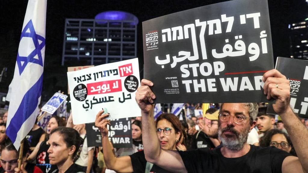 Protesters gather during an anti-government demonstration outside the defence ministry headquarters in Tel Aviv, calling for early elections, the return of the hostages held captive in the Gaza Strip since the 7 October attacks, and an end to the ongoing conflict in the Palestinian territory between Israel and Hamas.