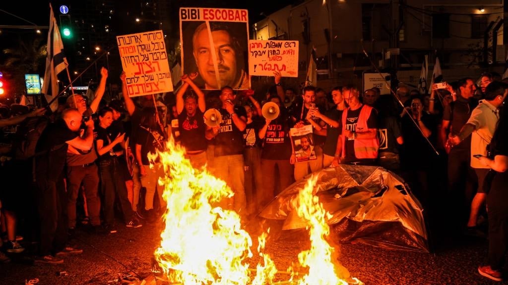 Protesters gather before a bonfire during an anti-