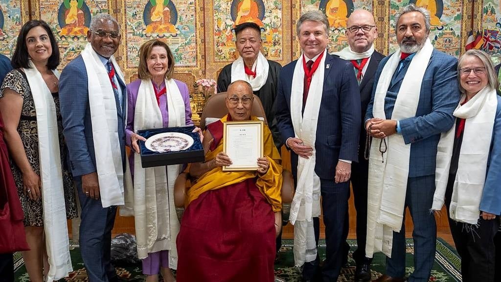 This handout photograph shows a group of senior US lawmakers including former House speaker Nancy Pelosi (3L) poses with Tibetan spiritual leader Dalai Lama (C) for photos after a meeting at his residence in Dharamsala. (Official website of Dalai Lama/AFP)