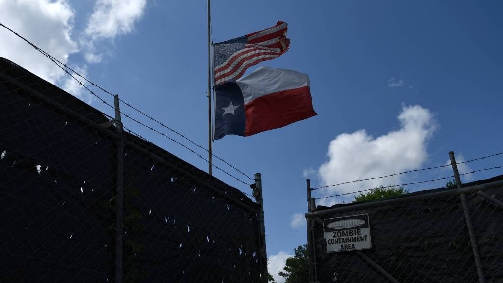 Flags fly at half-staff at a property reportedly o