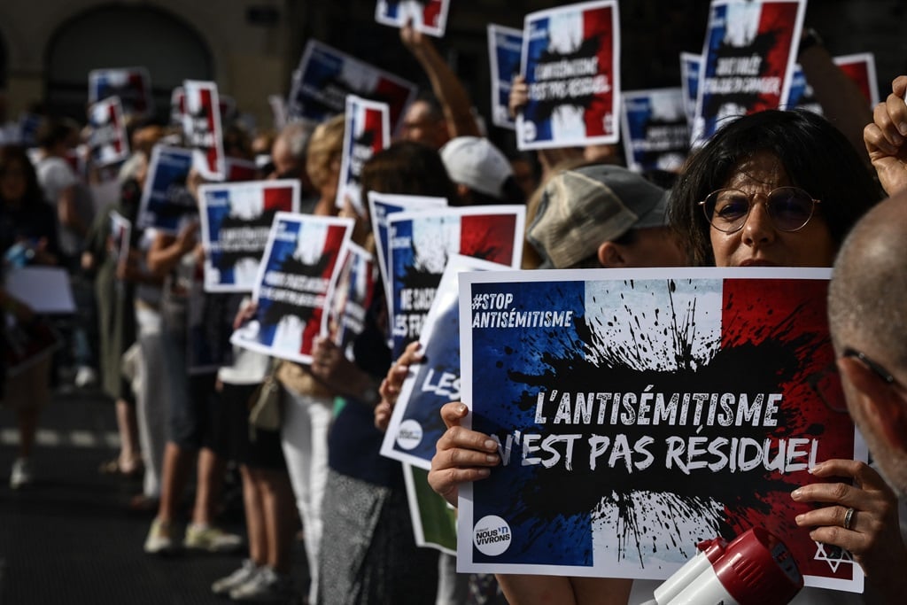 Protesters hold placards that read "Anti-semitism is not residual" during a rally in Lyon, France, in response to the reported gang rape of a 12 year-old girl. (JEAN-PHILIPPE KSIAZEK / AFP)