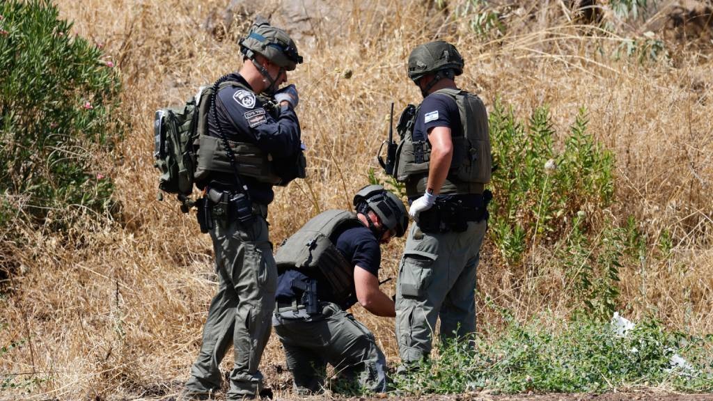 Members of Israeli security forces inspect sites w