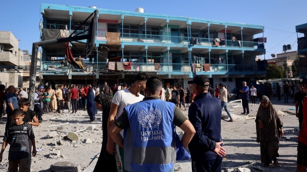 A member of the United Nations Relief and Works Agency for Palestine Refugees (UNRWA) checks the courtyard of the Al-Jawni (Jaouni) school after an Israeli air strike hit the site, in Nuseirat in the central Gaza Strip, amid the ongoing war in the Palestinian territory between Israel and Hamas. (Eyad Baba/AFP)