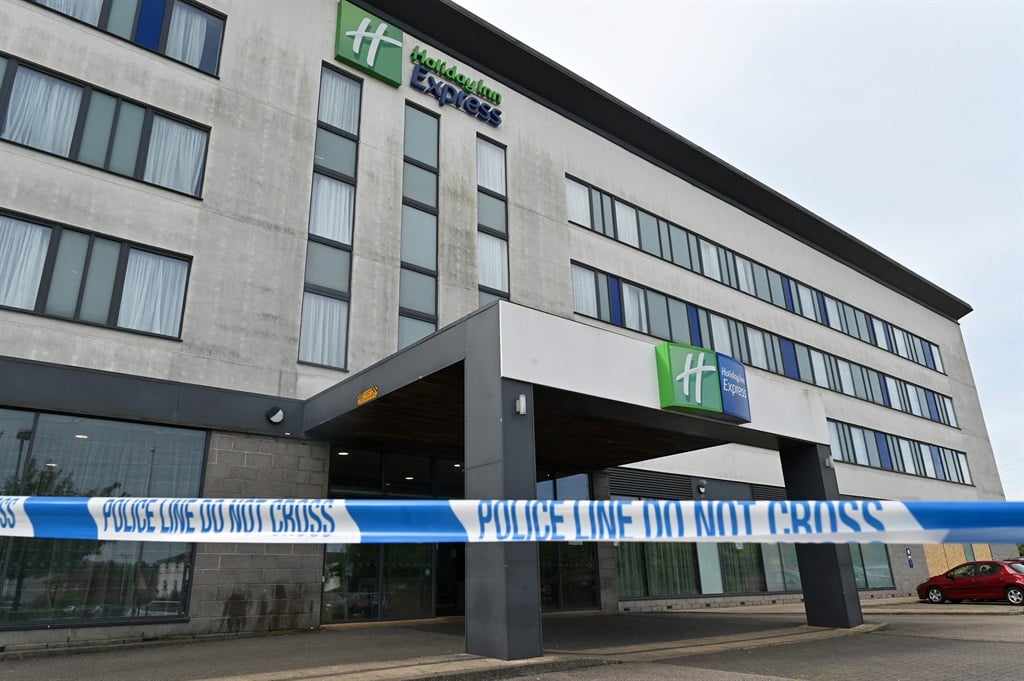 Police tape pictured at a Holiday Inn Express hotel in Manvers on the outskirts of Rotherham, northern England, on 13 August 2024. The scars of violence are still visible outside a hotel, believed at the time to be housing asylum seekers, in Rotherham, ten days after hundreds of men, some draped in the English flag, gathered outside chanting "kick them out" while overwhelmed police came under fire from bricks and burning objects. (Justin Tallis/AFP)