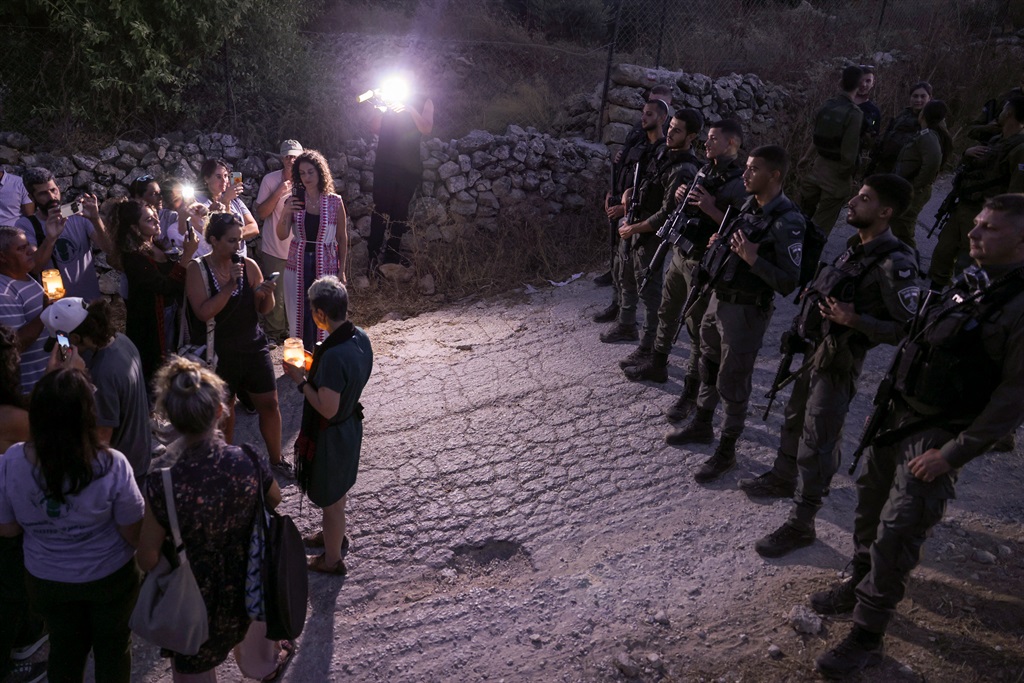 Activists are blocked by Israeli security forces from reaching a land confiscated by Israeli settlers in the al-Makhrur area near Beit Jala in the Israeli-occupied West Bank on 15 August 2024. (Hazem Bader/AFP)