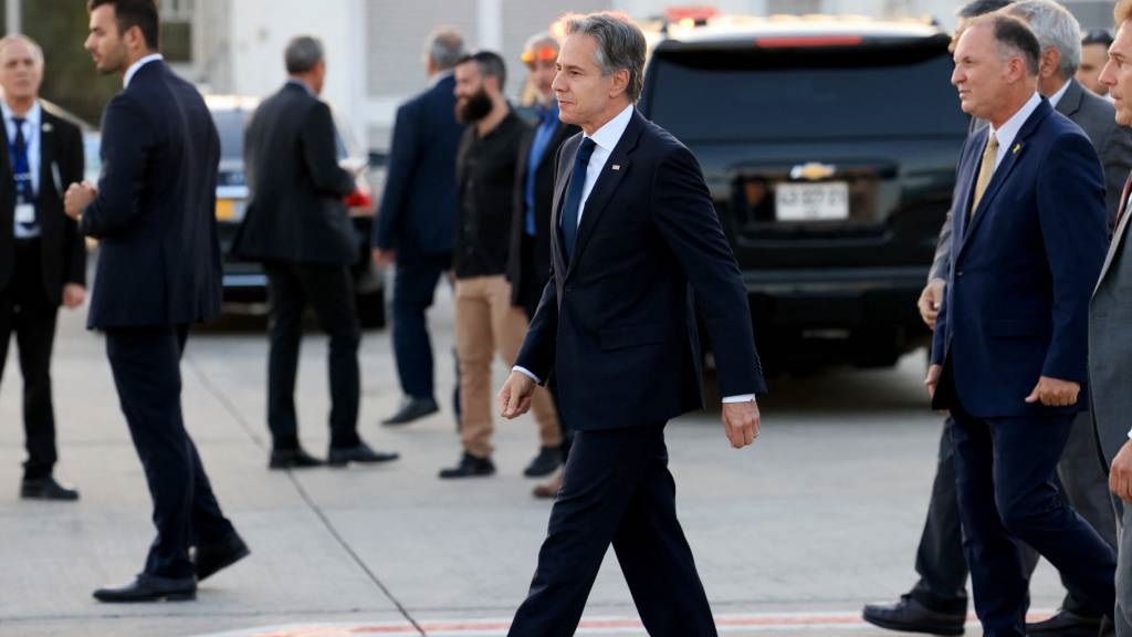 US Secretary of State Antony Blinken (C) walks aft