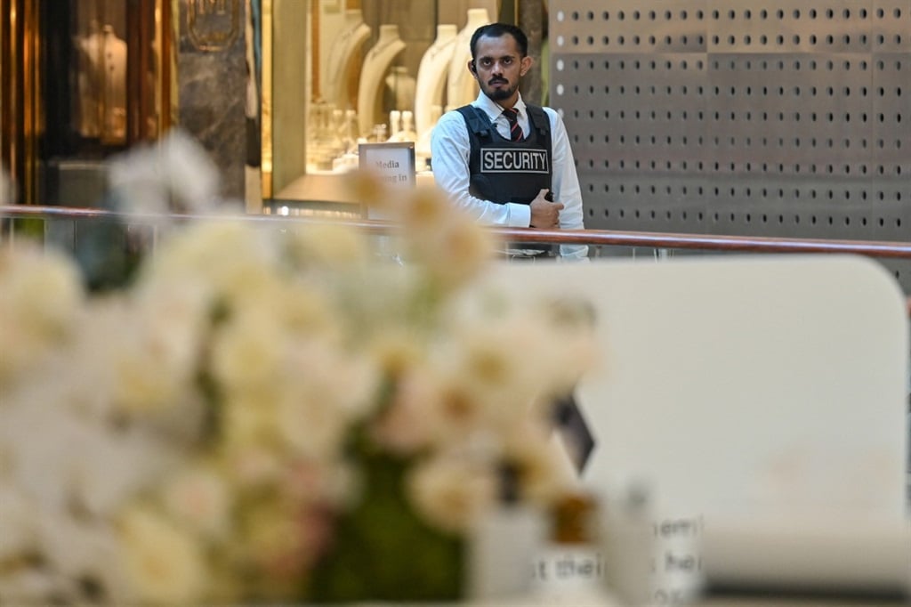 A security guard wears a 'stab-proof' vest as he keeps watch in Bondi Junction Westfield Shopping Centre in Sydney on 19 April 2024, nearly a week after a stabbing incident at the mall. (Ayush Kumar/AFP)